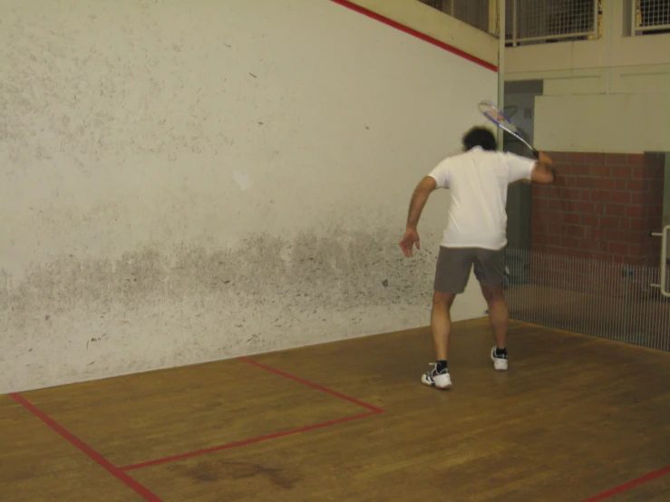 a young man holding a racket on a court