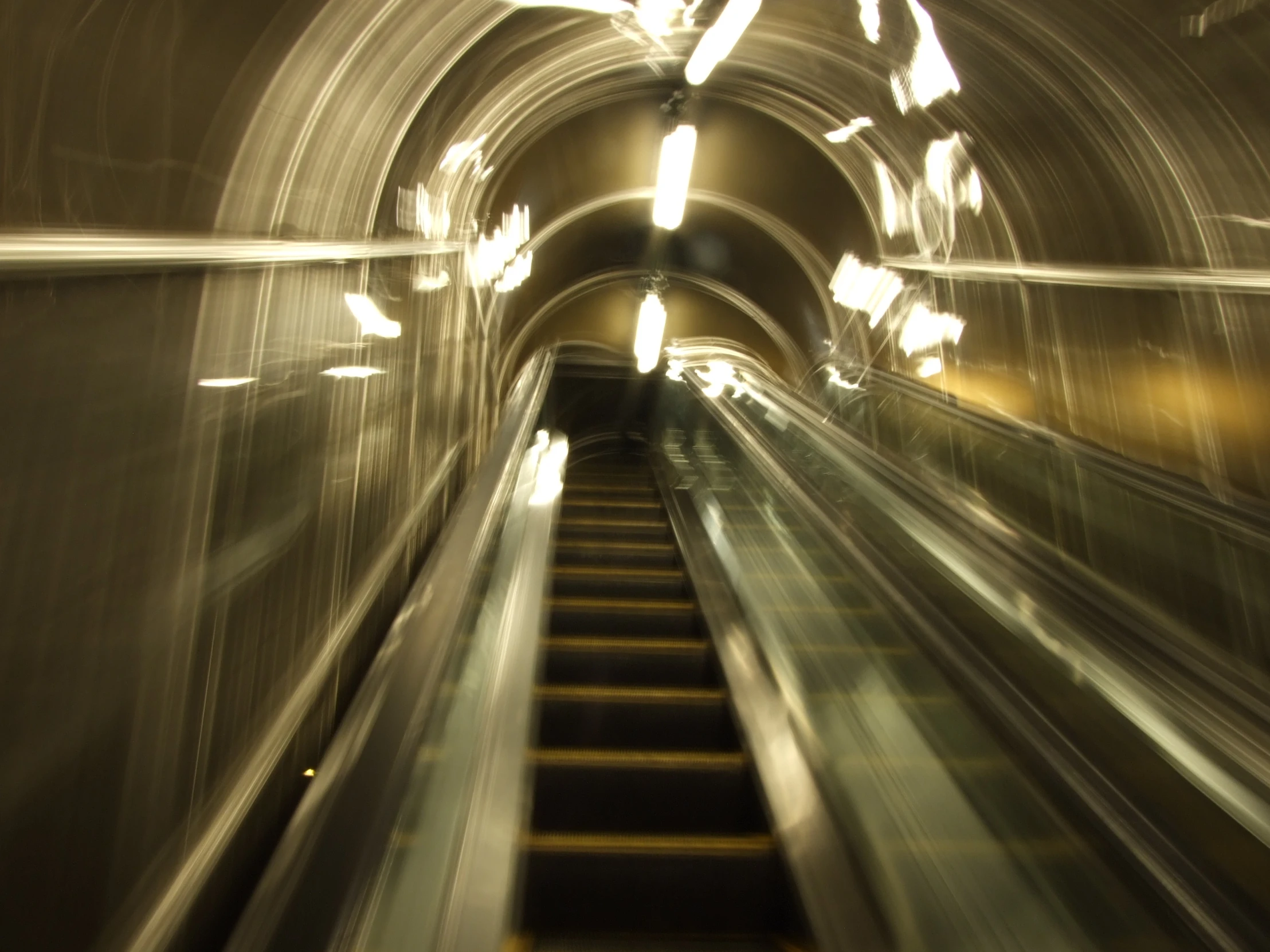 long, moving escalators that are going down an incline