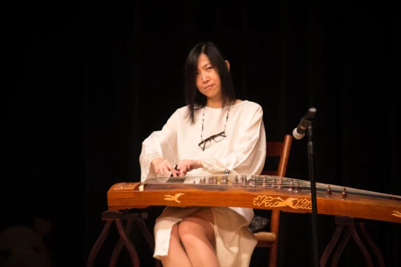 a woman is playing on a musical instrument