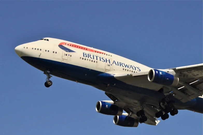 british airways plane in flight over london uk