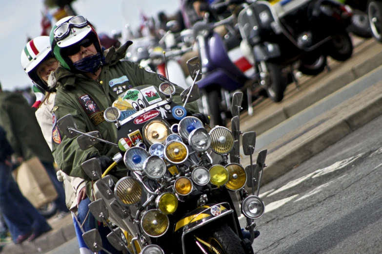 a person on a motor cycle with lots of assorted ons