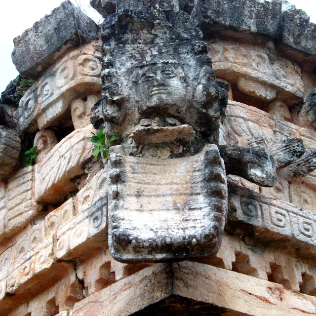 sculptures and heads at the top of a building