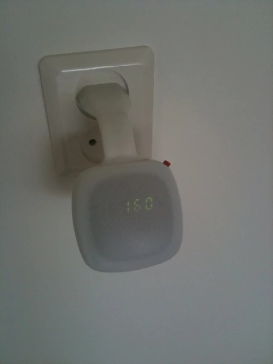 an air freshener dispenser on the wall with its timer