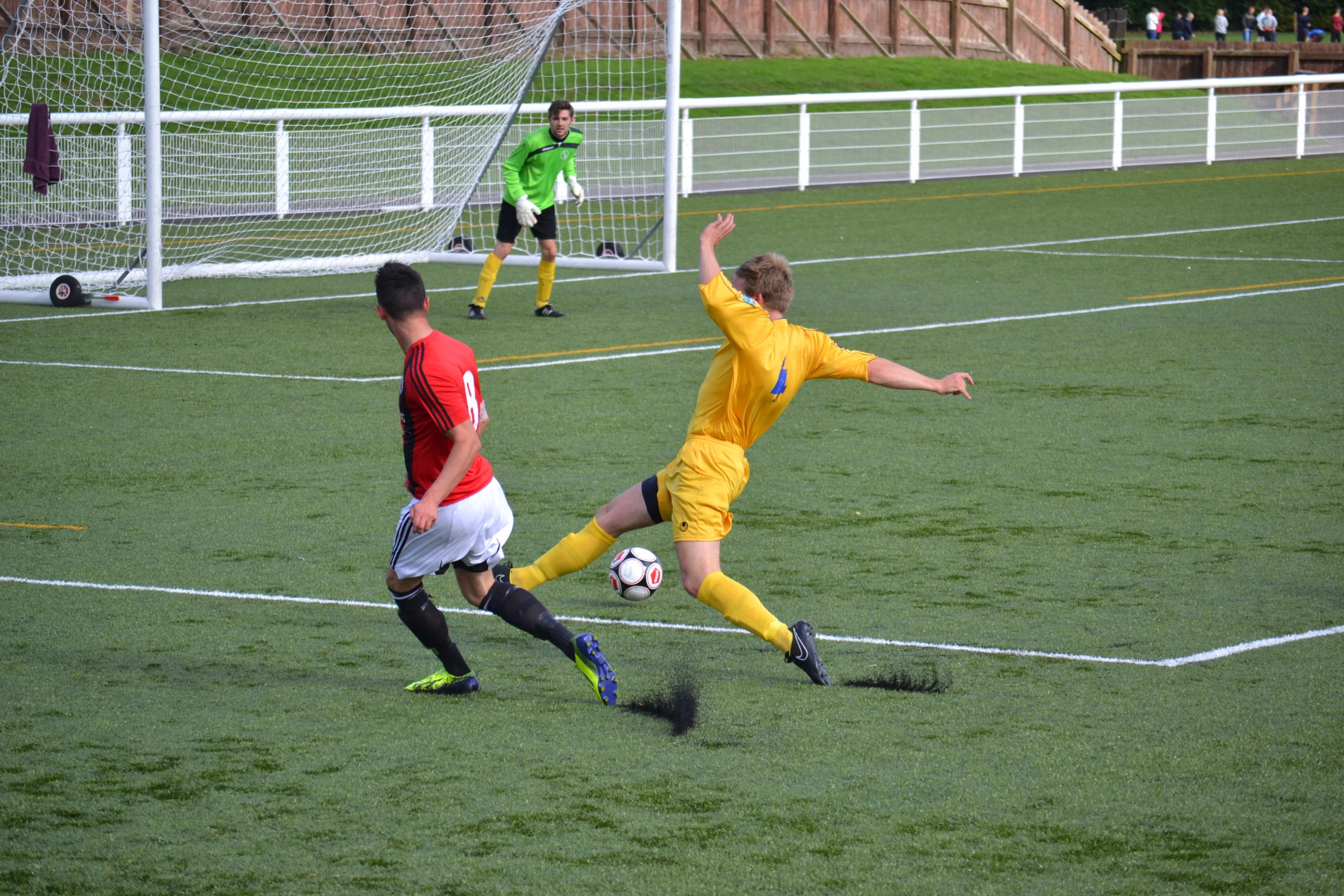 two men are playing soccer on the field