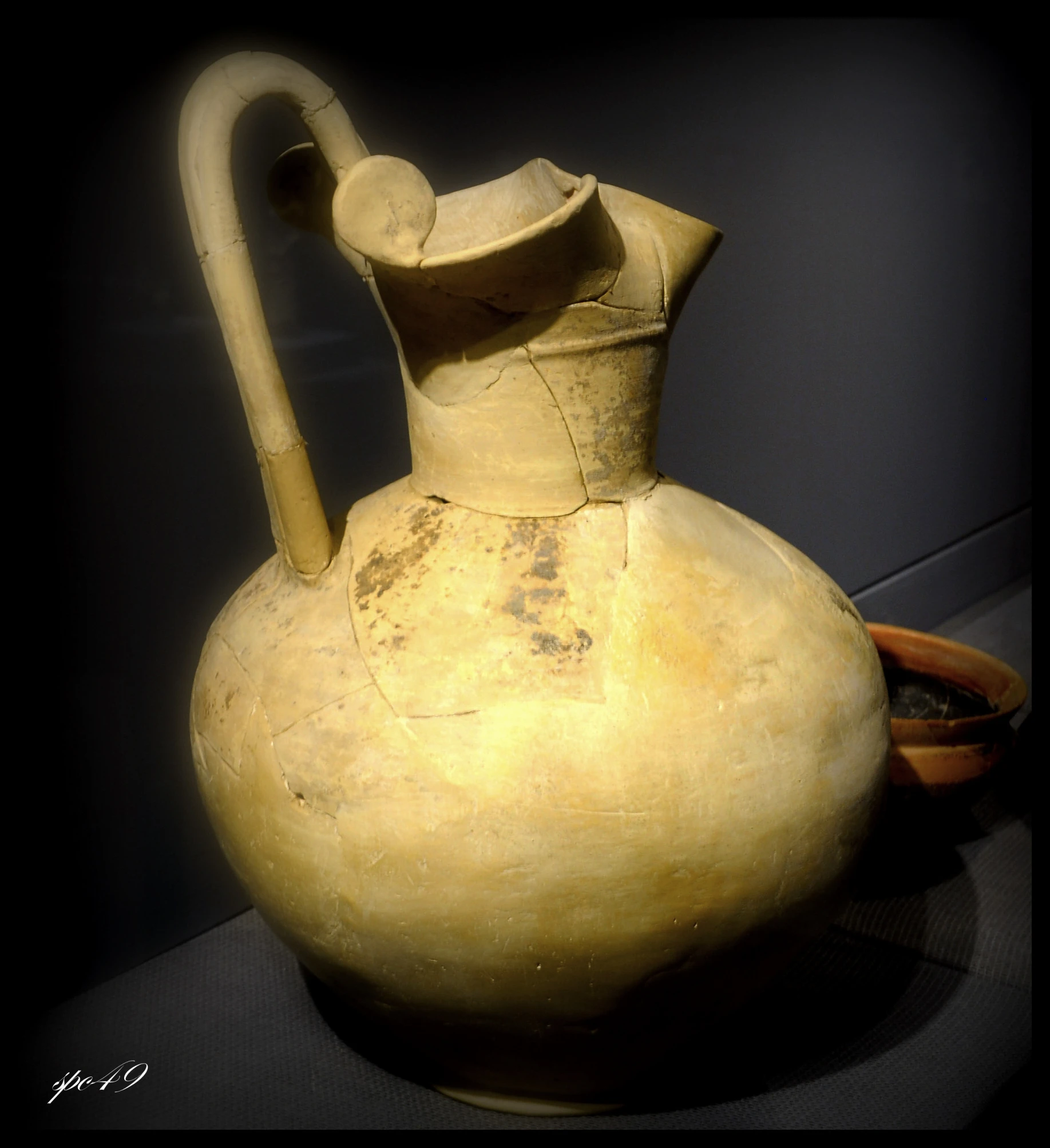 an old stone pitcher sits on a table