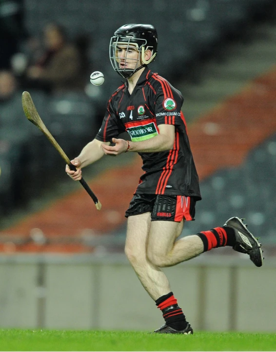 a man in uniform running with a stick