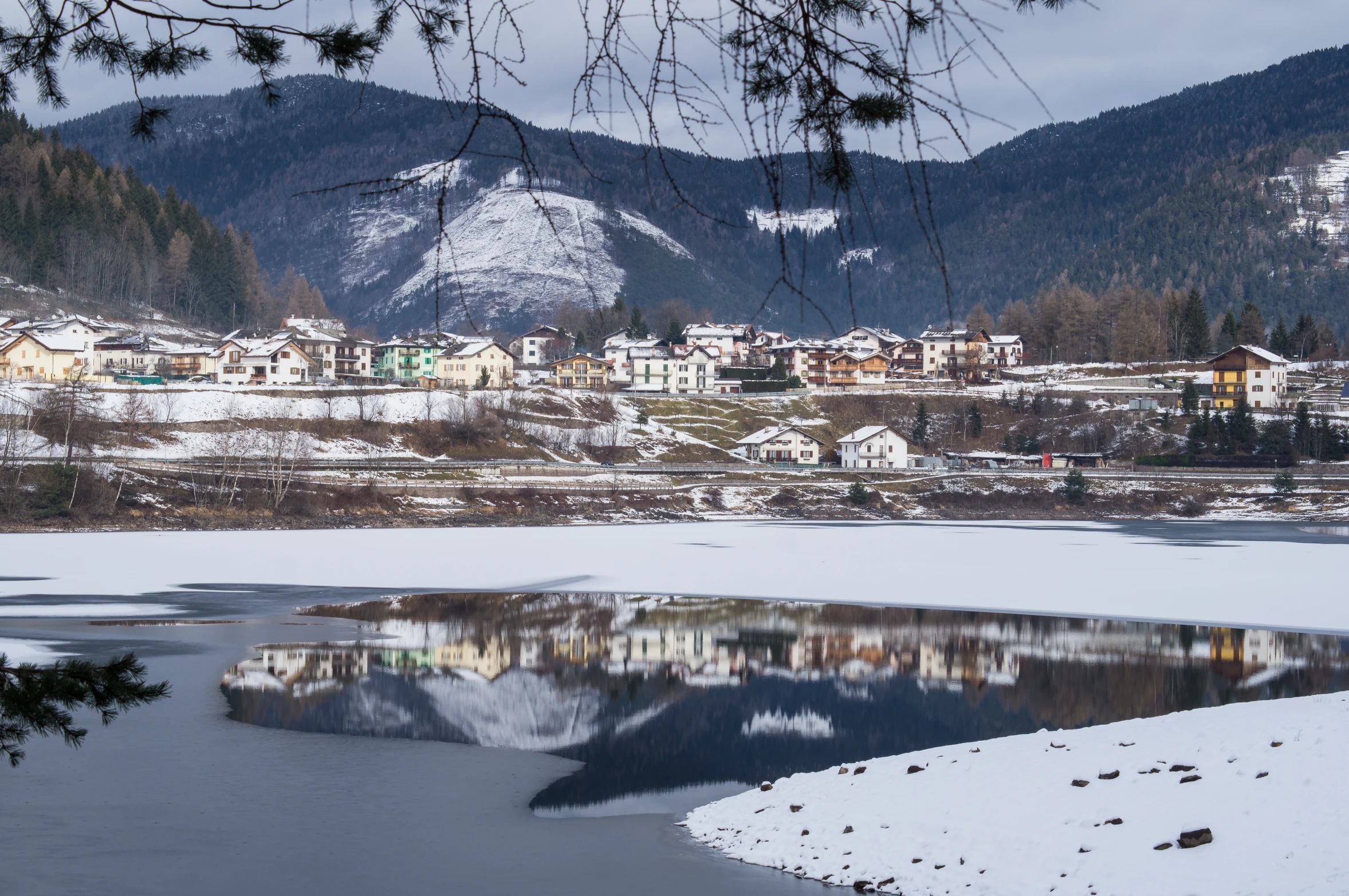 view of the mountains over a snowy river