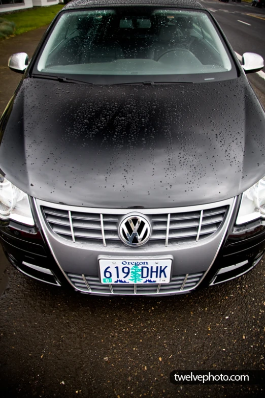 a black car that is parked in the street