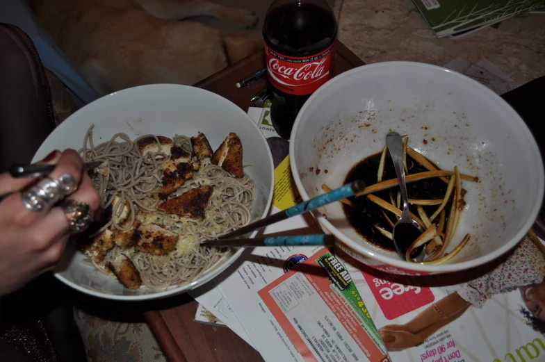 two bowls full of food sit on top of the table