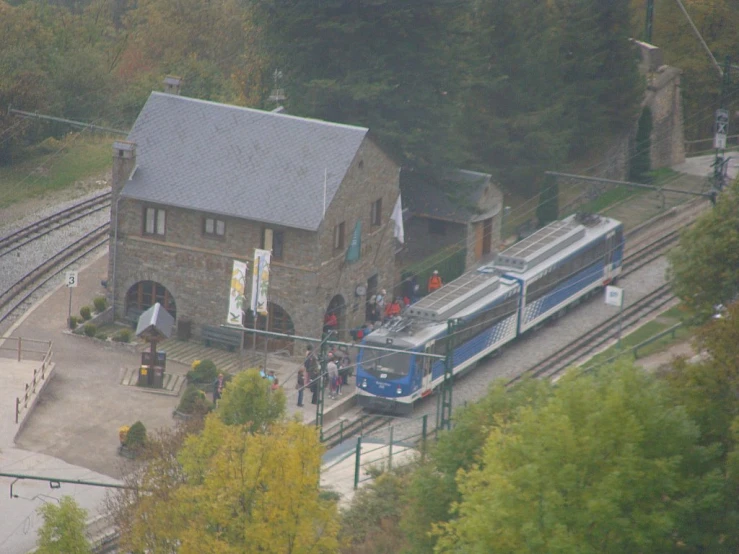 there are people waiting for a train to arrive