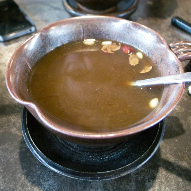 a bowl of soup is sitting on a tabletop