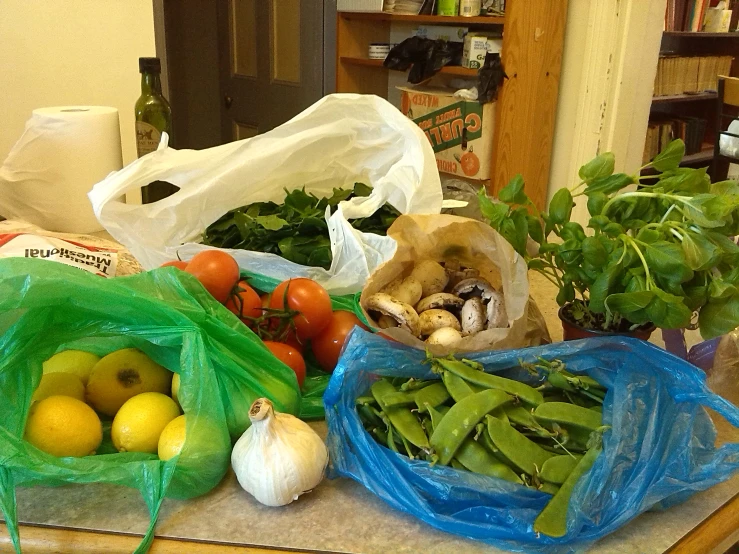 an assortment of vegetables and fruits on a counter