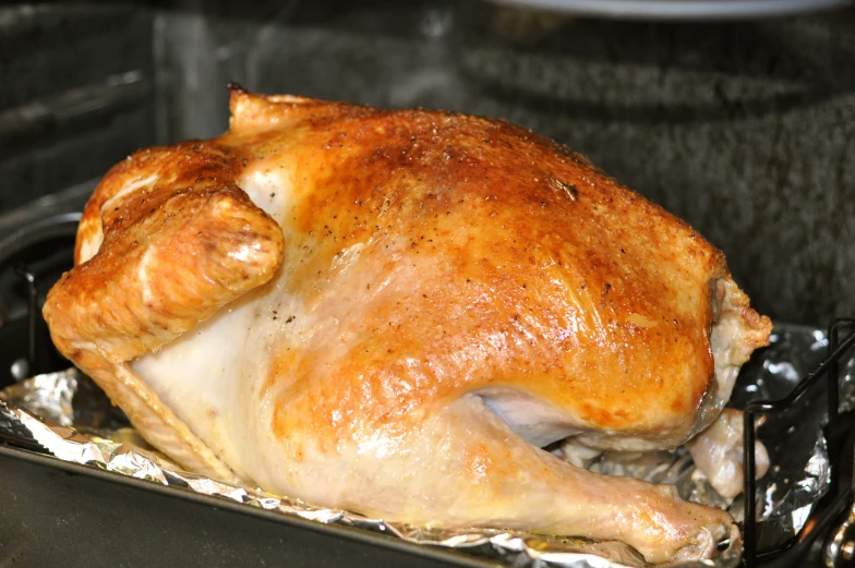 a roasted chicken on a grill in the oven