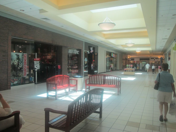 a store has red chairs and white tile floors