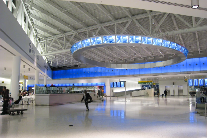 people walking around in the lobby at an airport