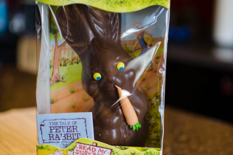 a box containing some kind of fake bunny with a pen in its mouth