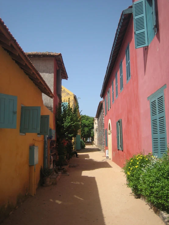 a couple of red buildings that have shutters