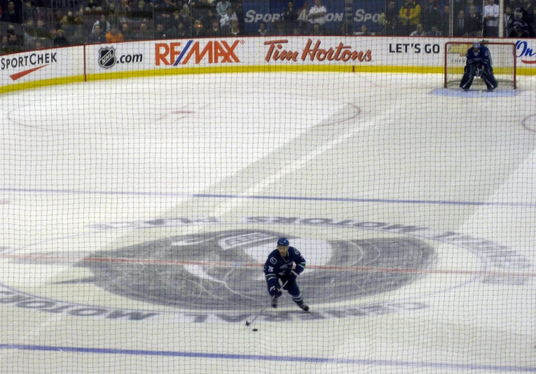 a hockey goalie on the ice with an image of a person