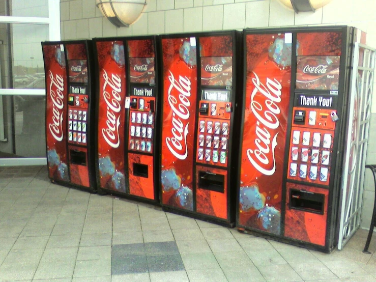 coca - cola machine displayed in front of a restaurant