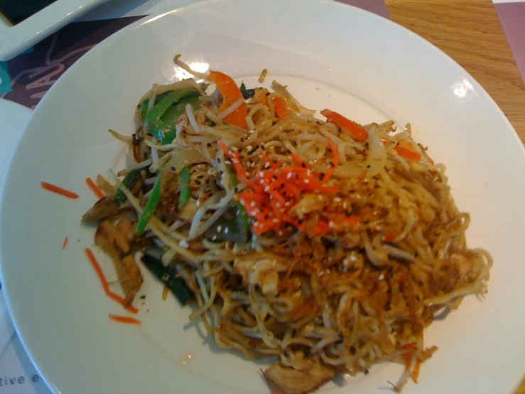 a plate full of noodles and vegetables on top of it