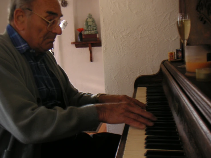 the older man is playing a grand piano