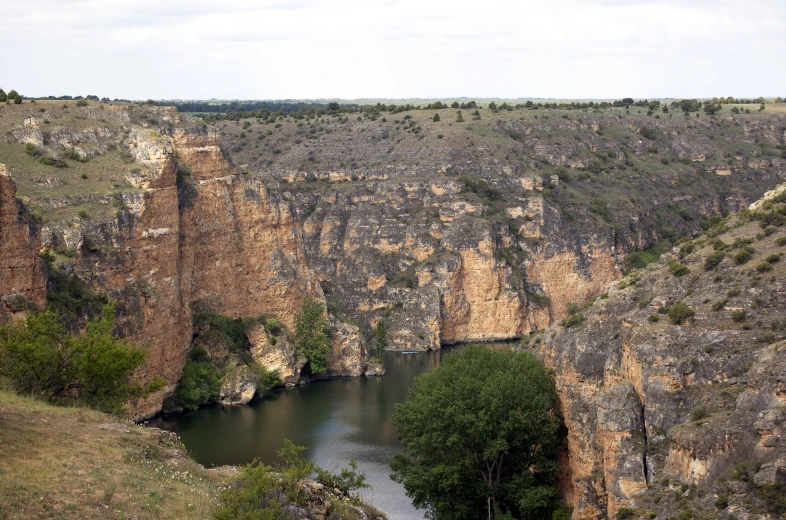 a river cuts into an area of rocky mountains