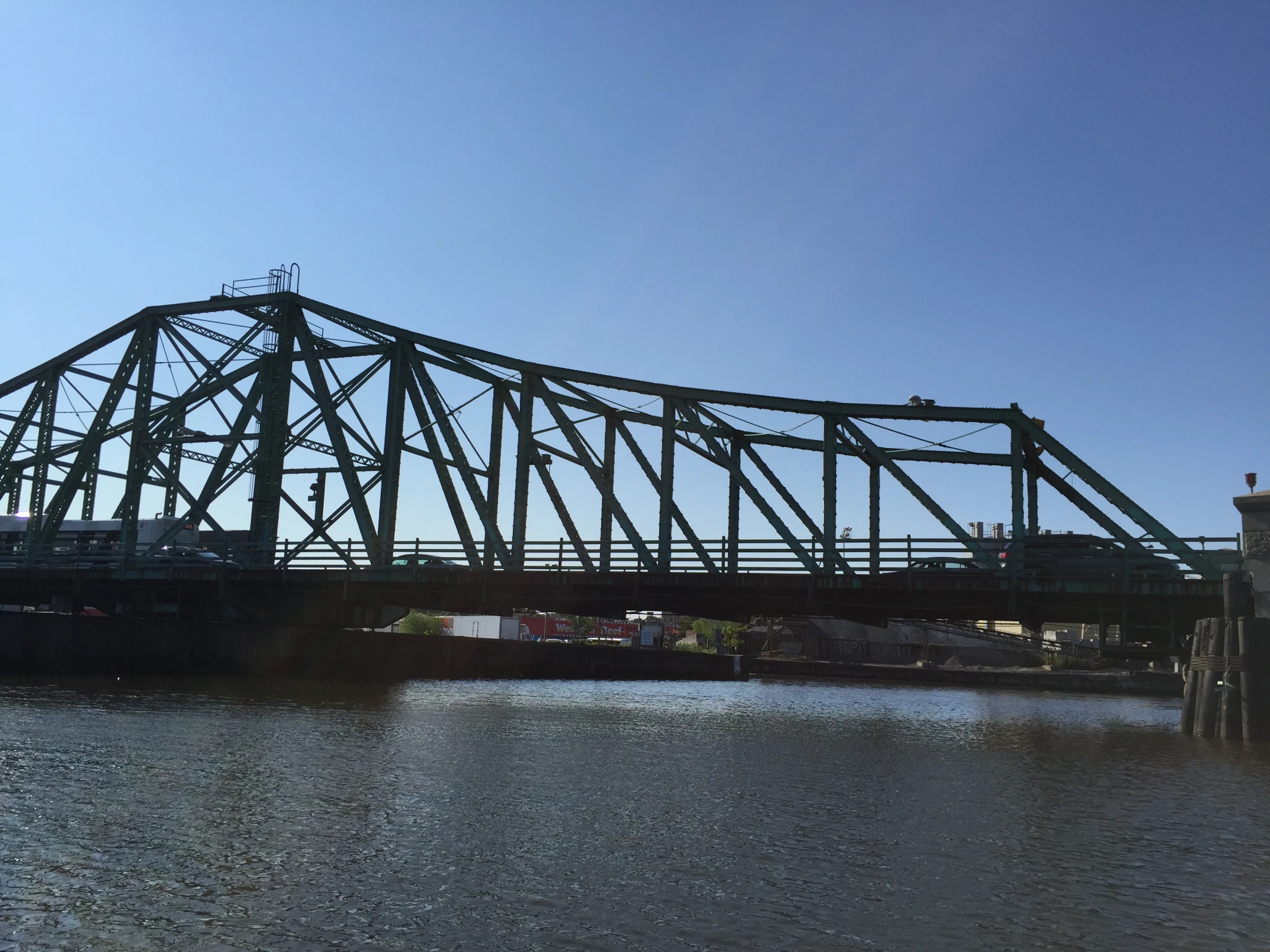 an old bridge on the water going over it