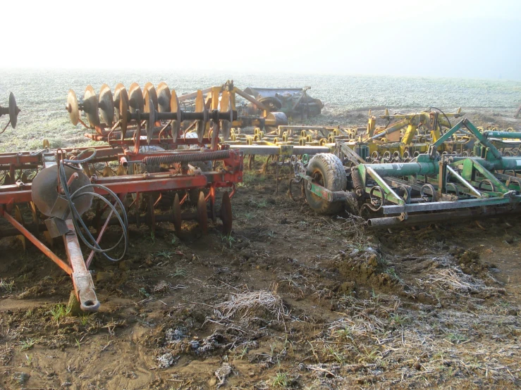 an old farm machine is in the dirt