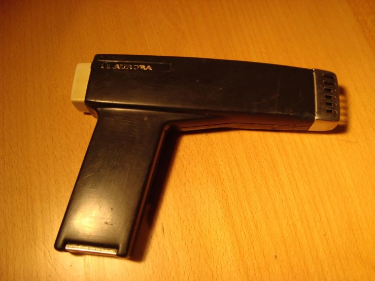 a close up of a broken black object on a table