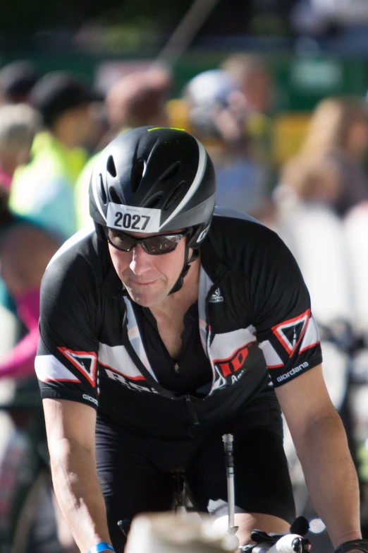 a cyclist on the side of a bicycle course