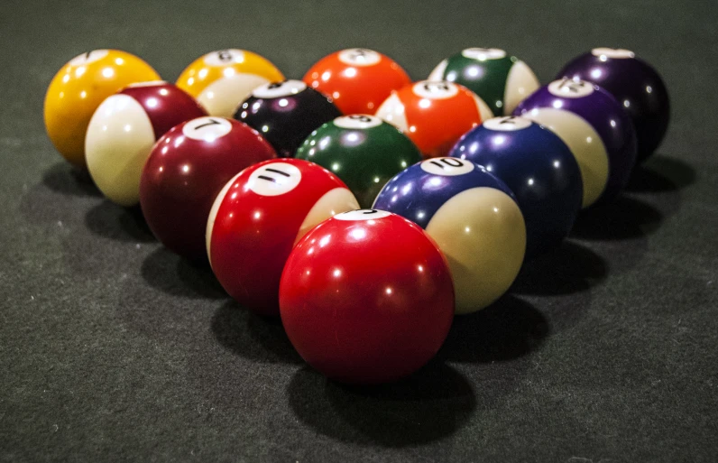 a row of pool balls sitting in a line
