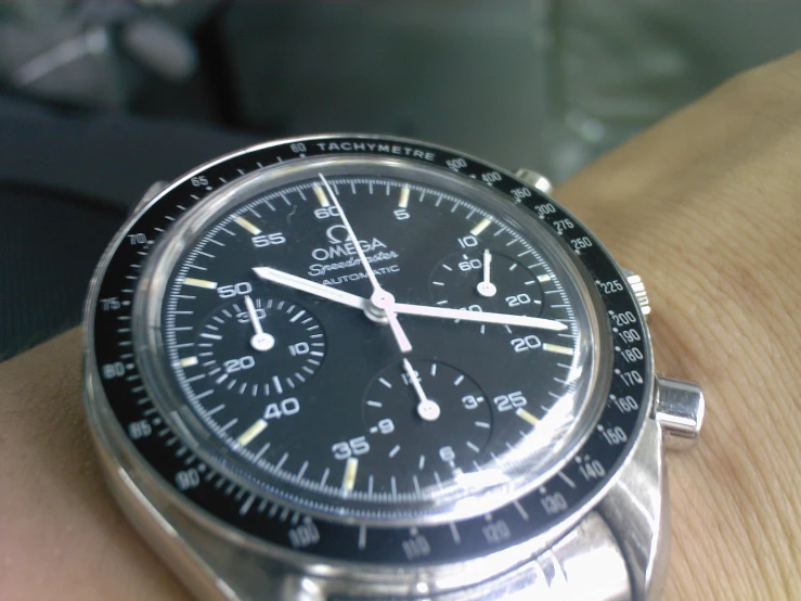 the wrist is holding an older watch with many functions