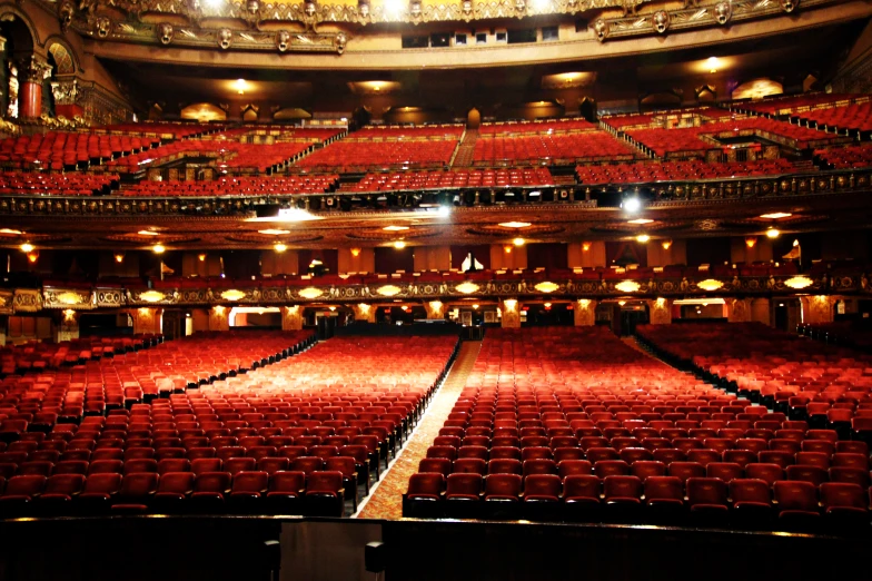 a large auditorium with many red seats