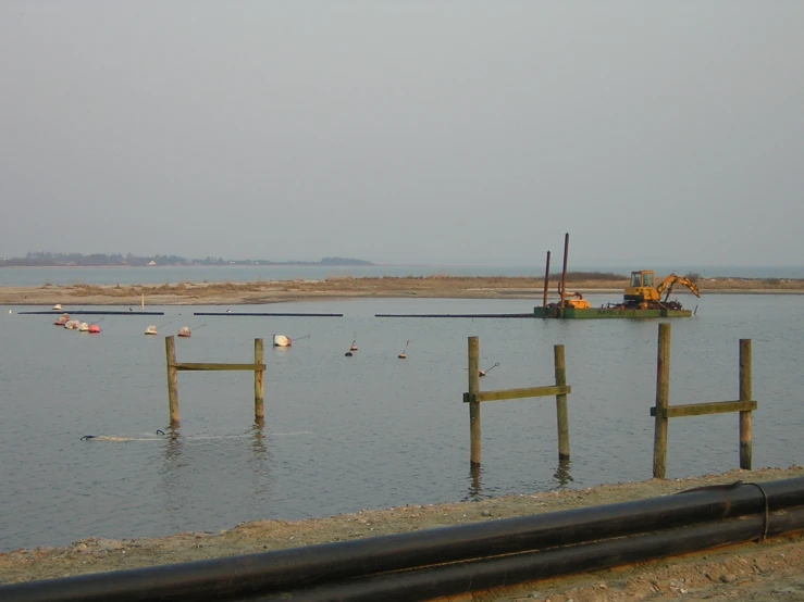 a lake with boats floating and buoys