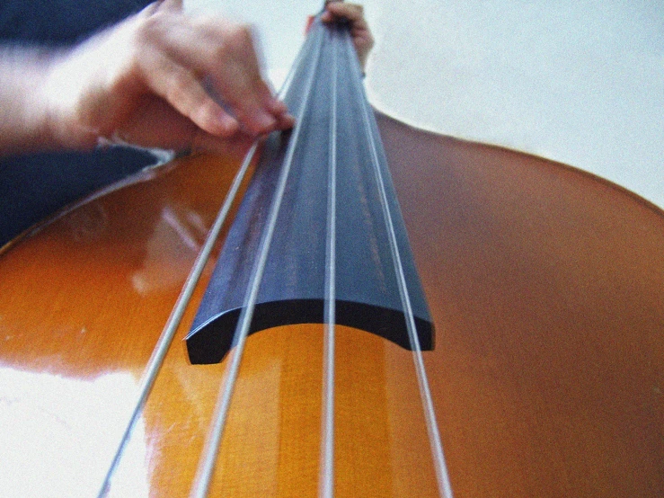 the person is trying to see the strings on this instrument