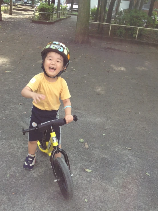 a small boy is riding his bike outside