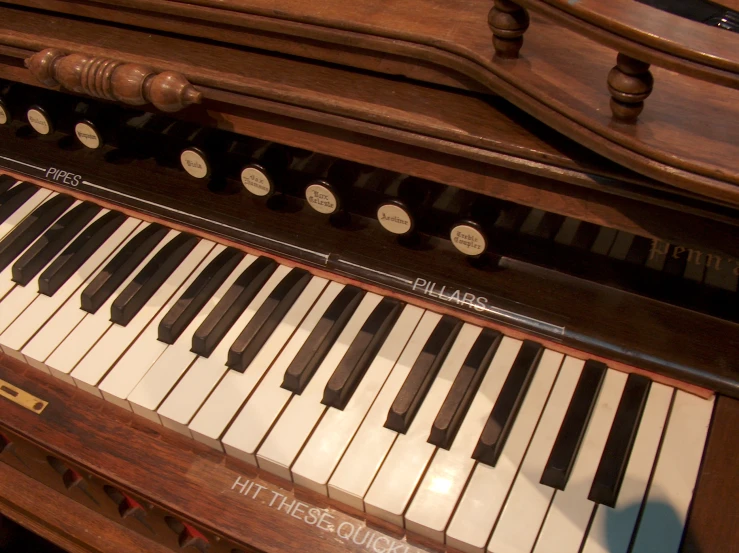 an antique piano is sitting in the corner