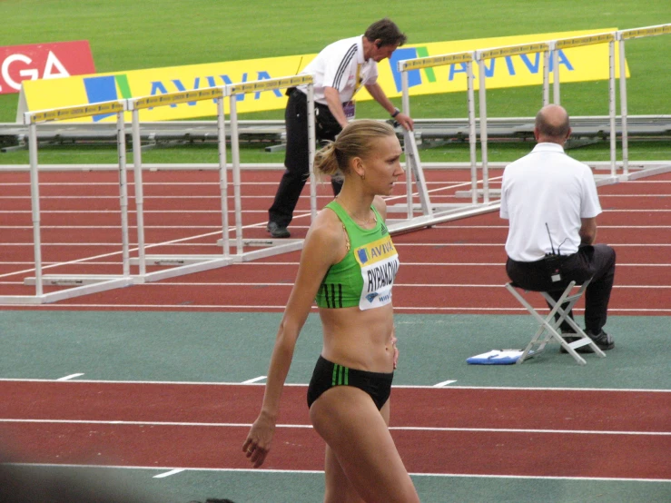 a female runner is on the side of a track