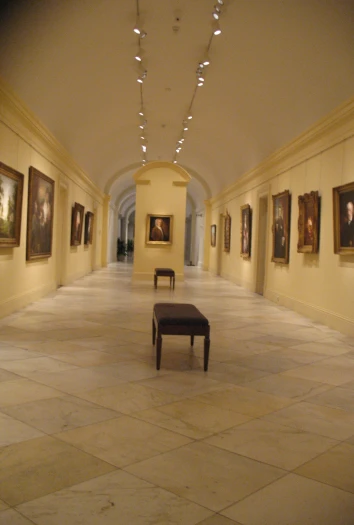 a long hall with some benches sitting next to them