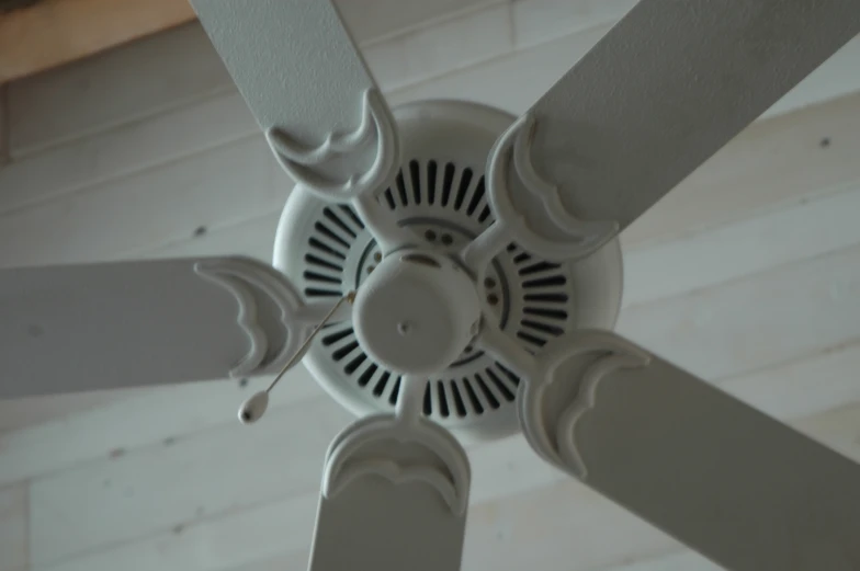 a ceiling fan is mounted to the outside wall