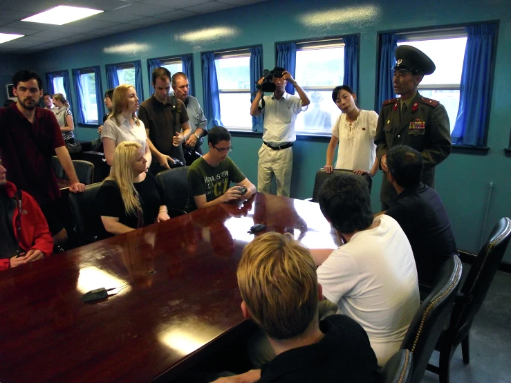 several people sitting at tables around a conference room