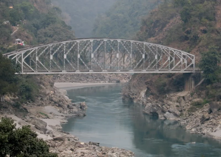 a bridge over a river with a train on it