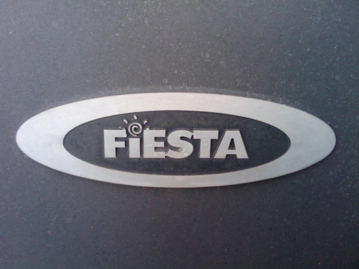 the fiesta logo is in white and black on a dark background