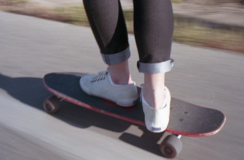 a person riding a skateboard on a city street