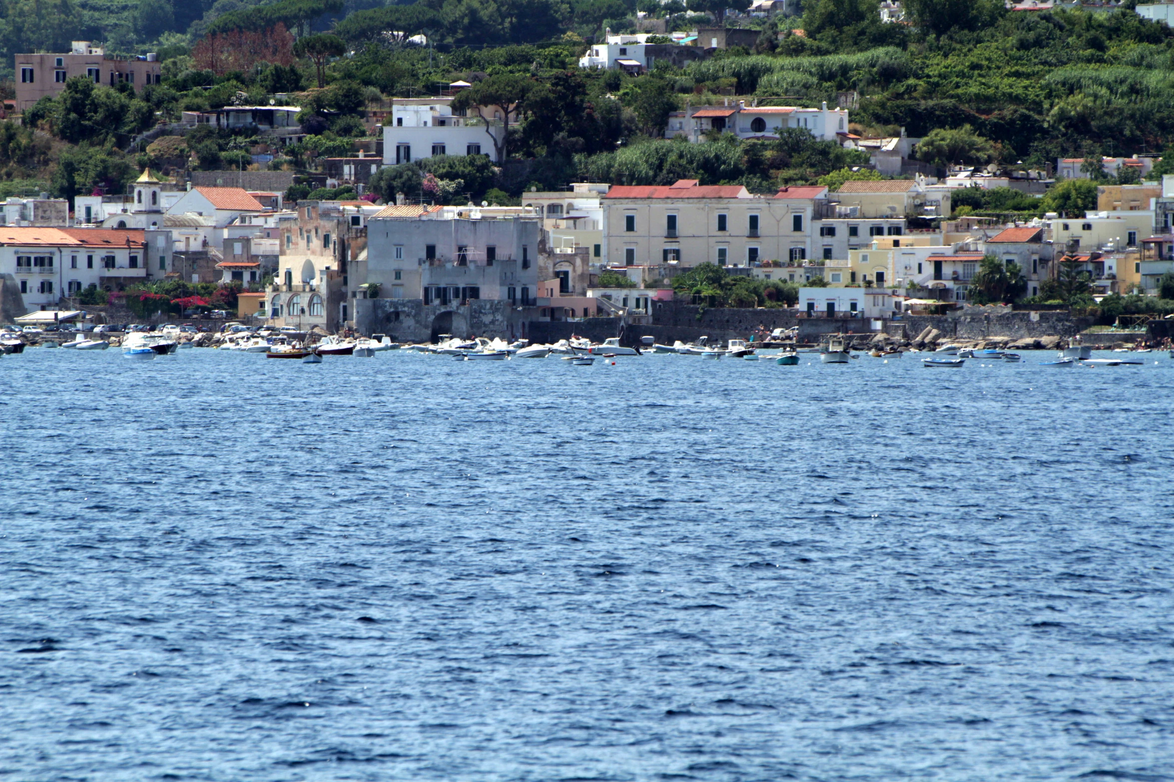 a city that is sitting on a hill by water