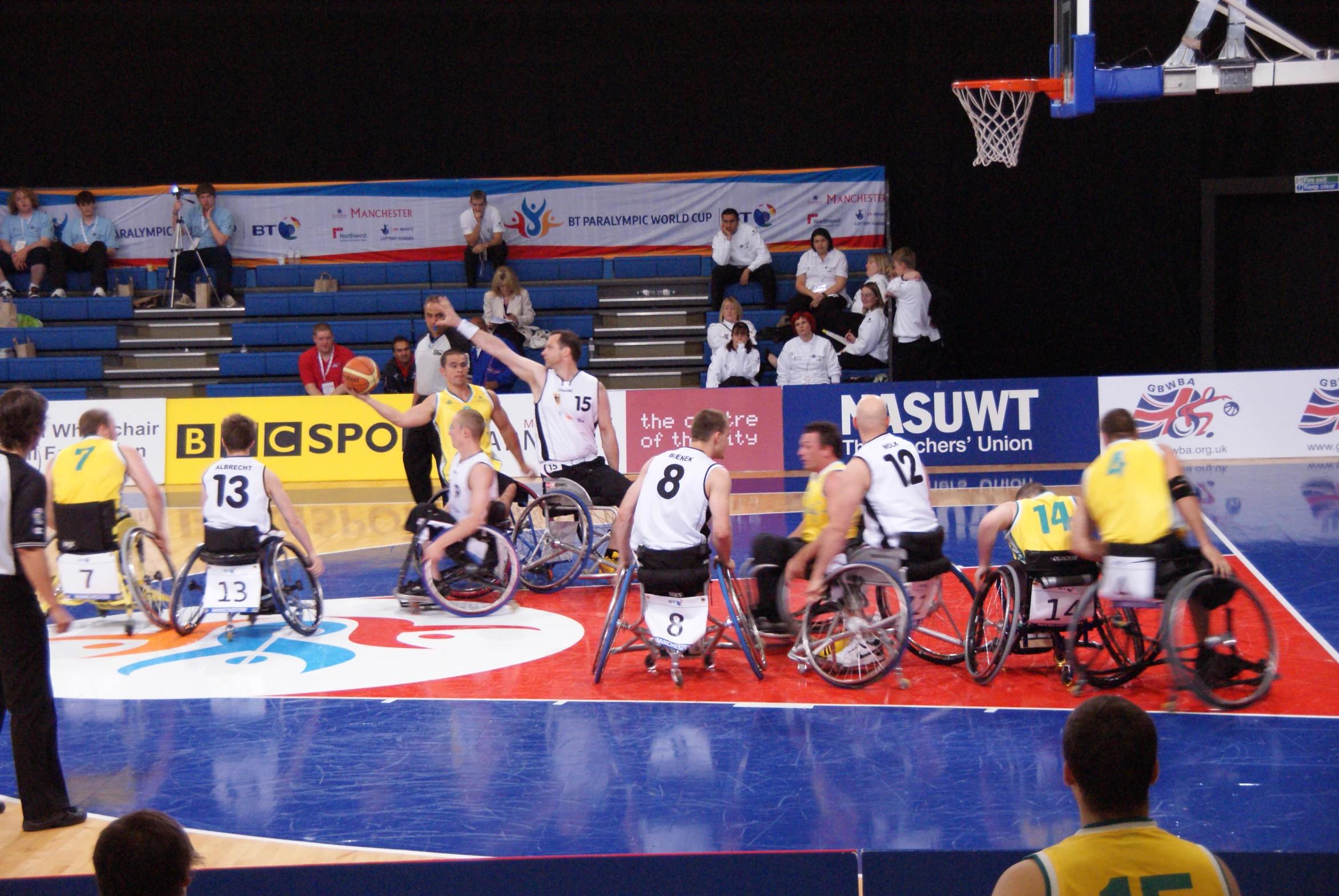 wheelchairs in the middle of an arena playing a game