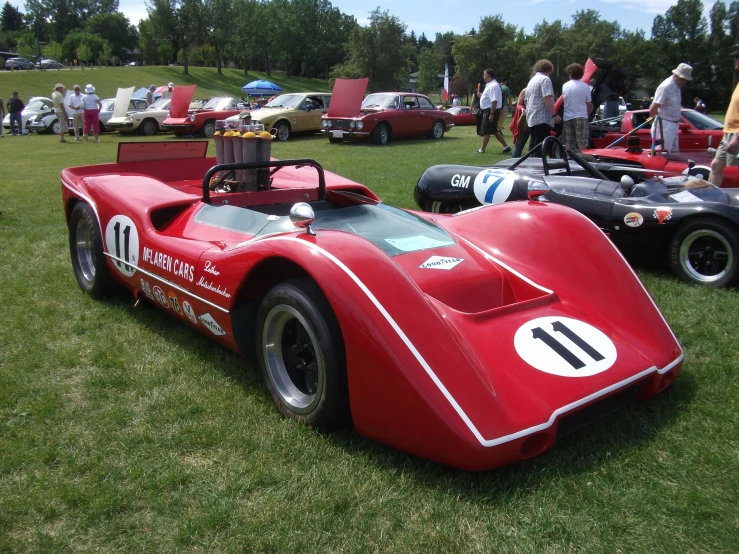 old race car at a sports event with other cars