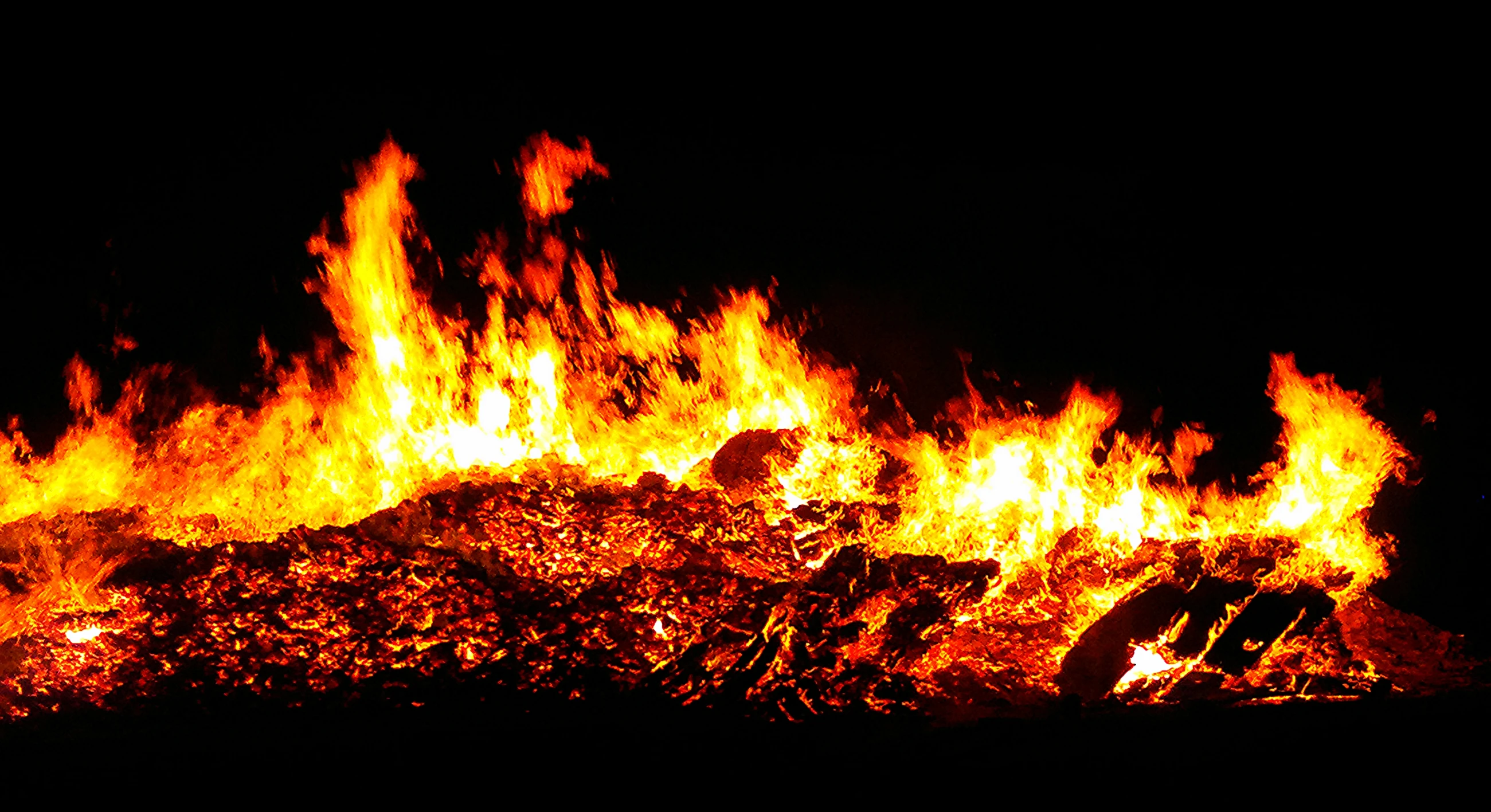 a pile of rocks and fire at night