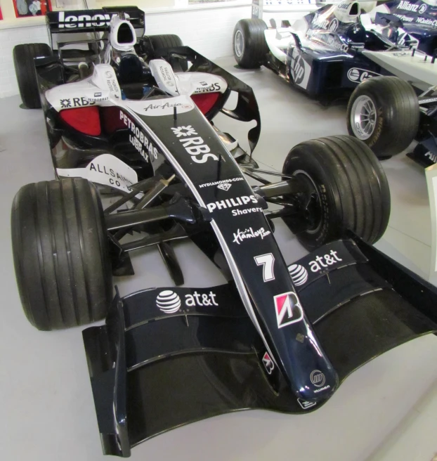 a small group of racing cars are parked together