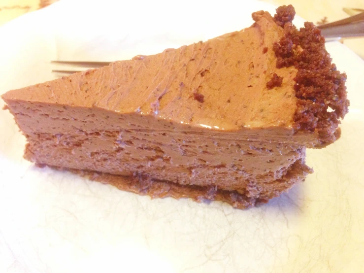 there is a slice of cake that has chocolate frosting